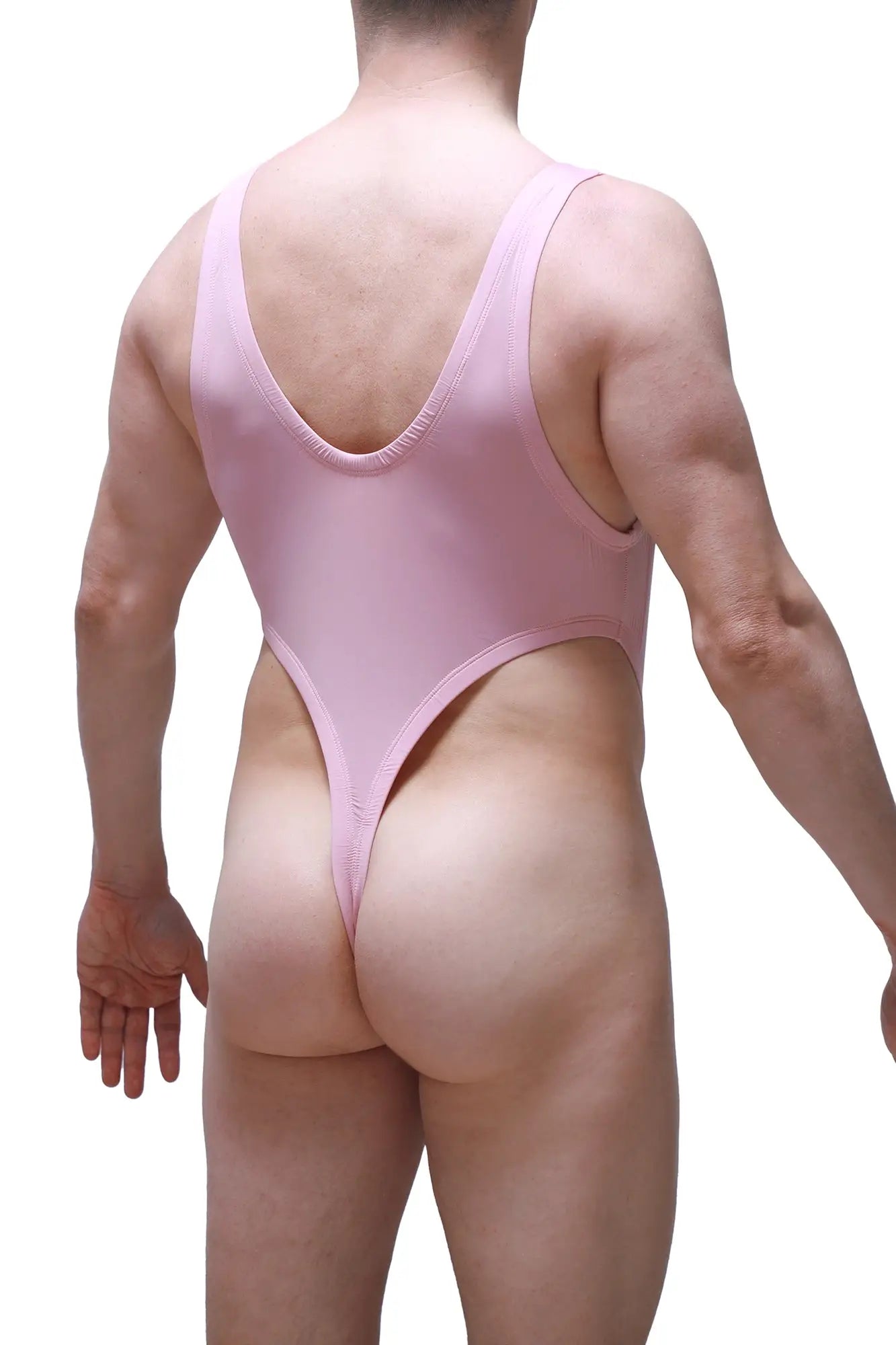 A sleek pink petitq bodythong gonzac skine tea rose one-piece swimsuit shown from the back with a deep v-back and high-cut legs