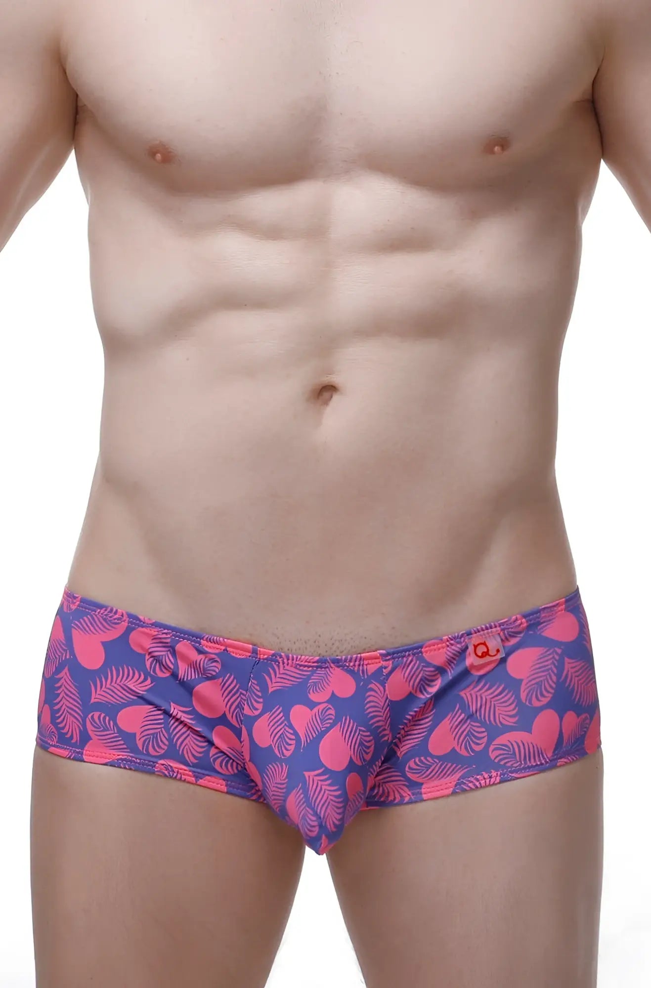 Vibrant pink and purple petitq boxer chill swim trunks with heart and leaf patterns perfect for tropical wear