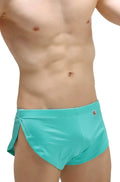 PetitQ running shorts Joe Green turquoise swim trunks with side slit and small red logo on waistband in front view