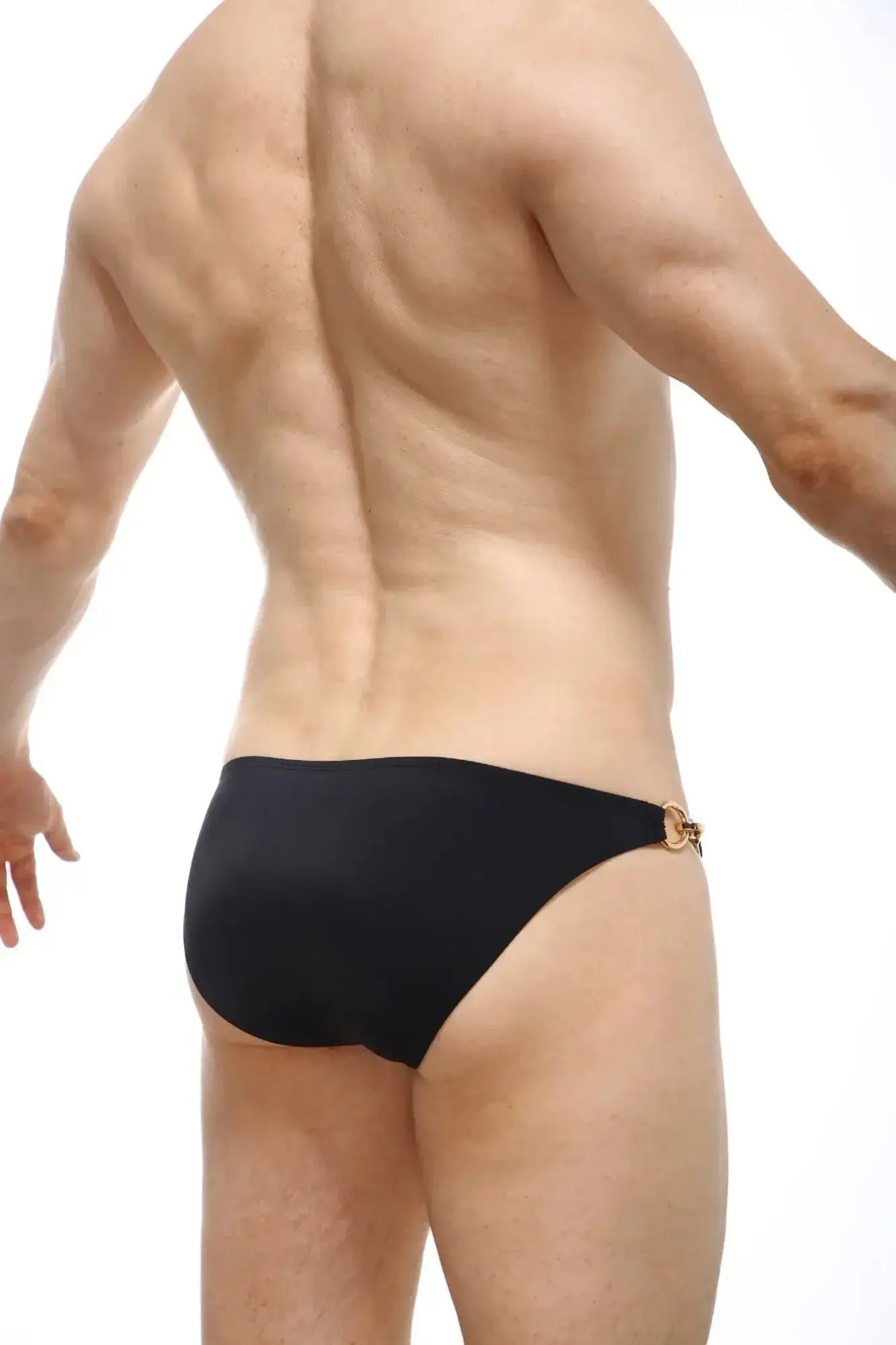 Black swim trunks from PetitQ swim bikini Conguel with gold-toned metal clasp at the waistband back view