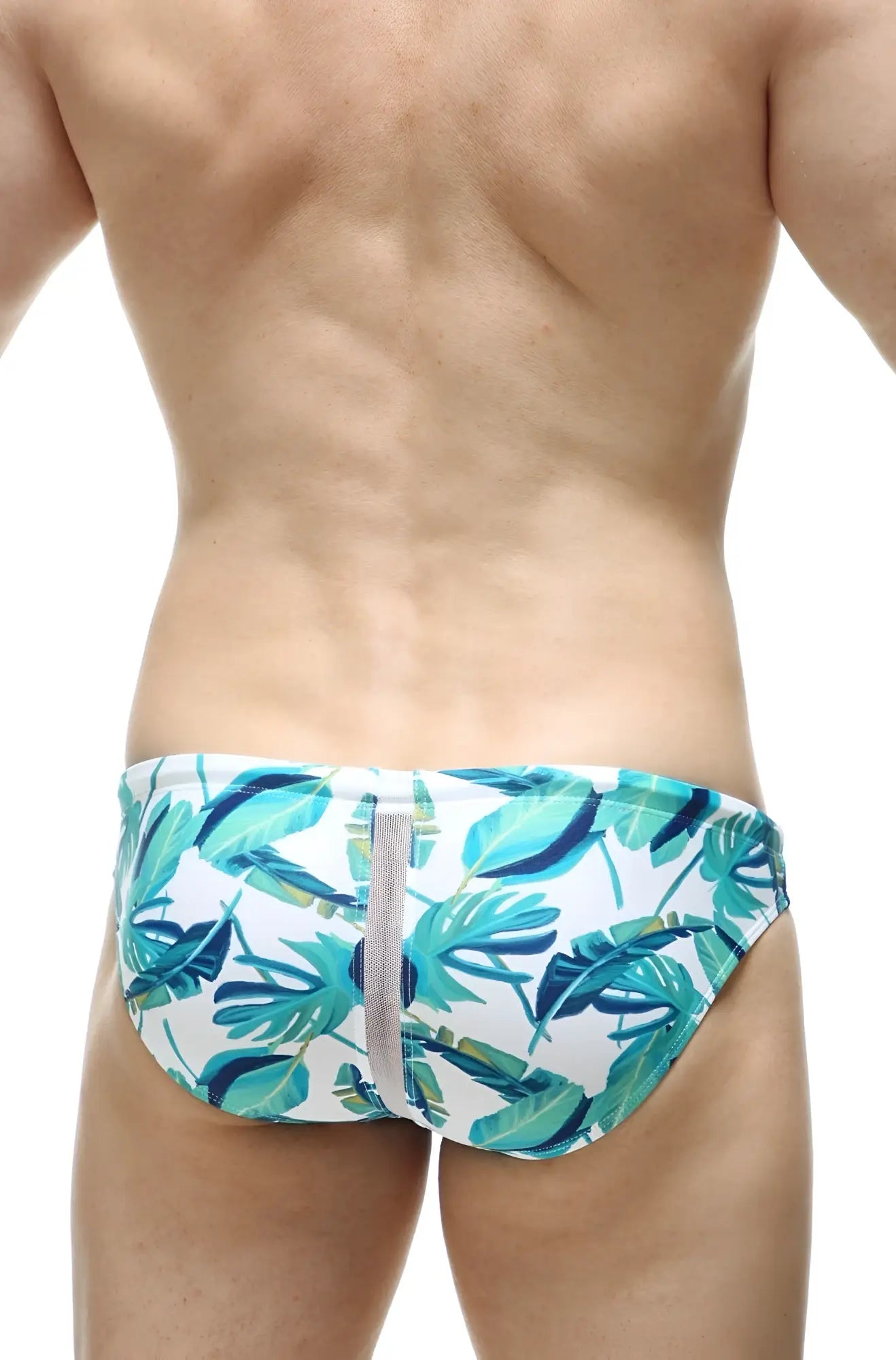White swim trunks petitq swim bikini tarcu macouba with vibrant teal and green tropical leaf pattern and central gray zipper