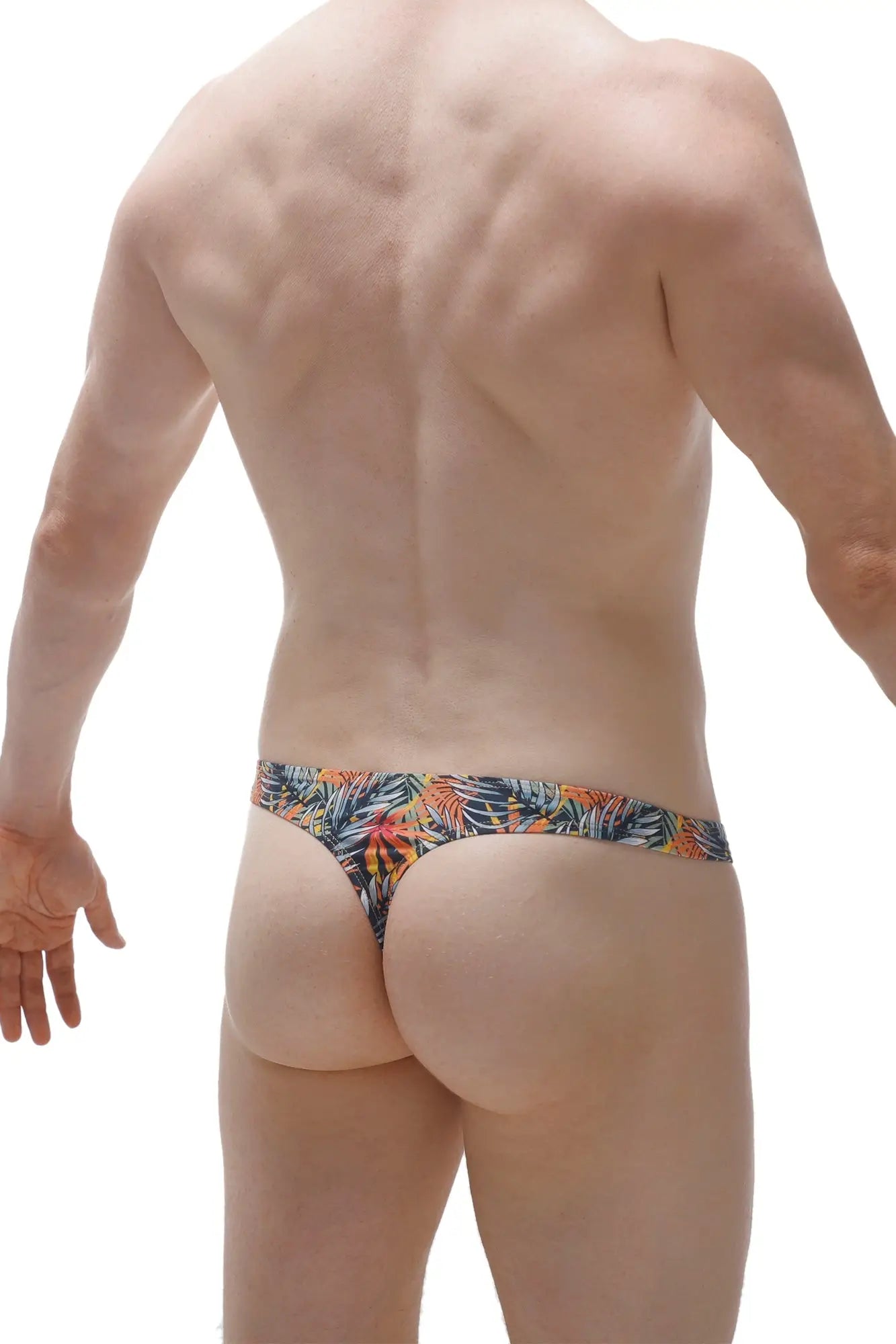 PetitQ swim thong clip Papeete in tropical leaf pattern with vibrant orange green and blue on dark fabric base