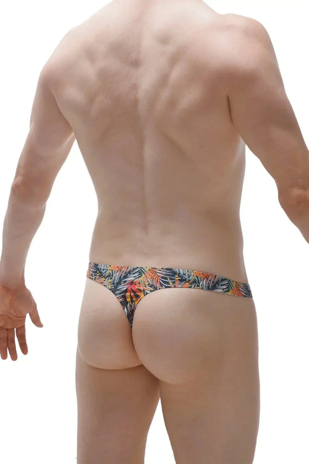 PetitQ swim thong clip Papeete in tropical leaf pattern with vibrant orange green and blue on dark fabric base