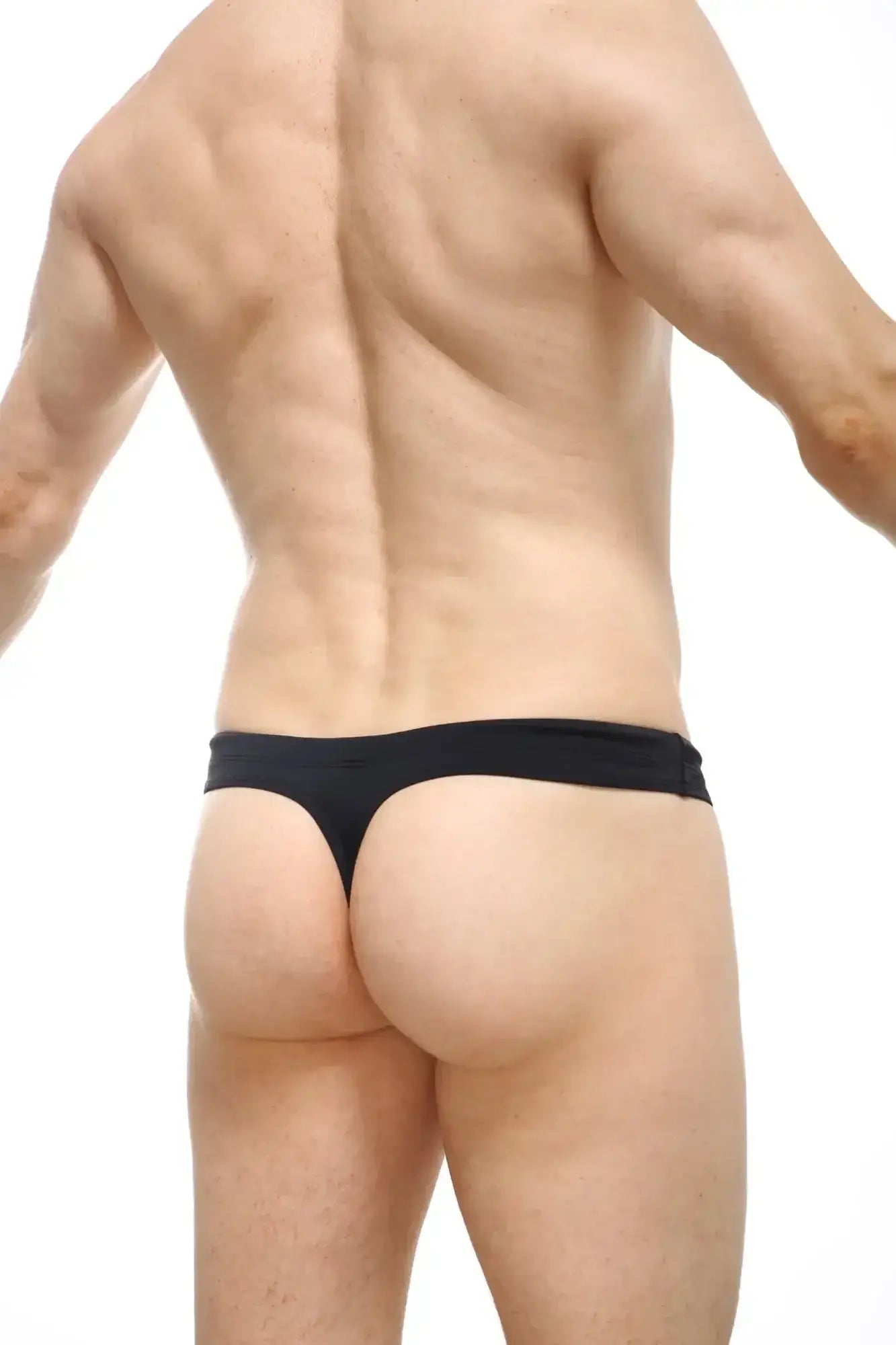 Black thong underwear with smooth stretchy fabric waistband made from recycled material by petitq swim thong