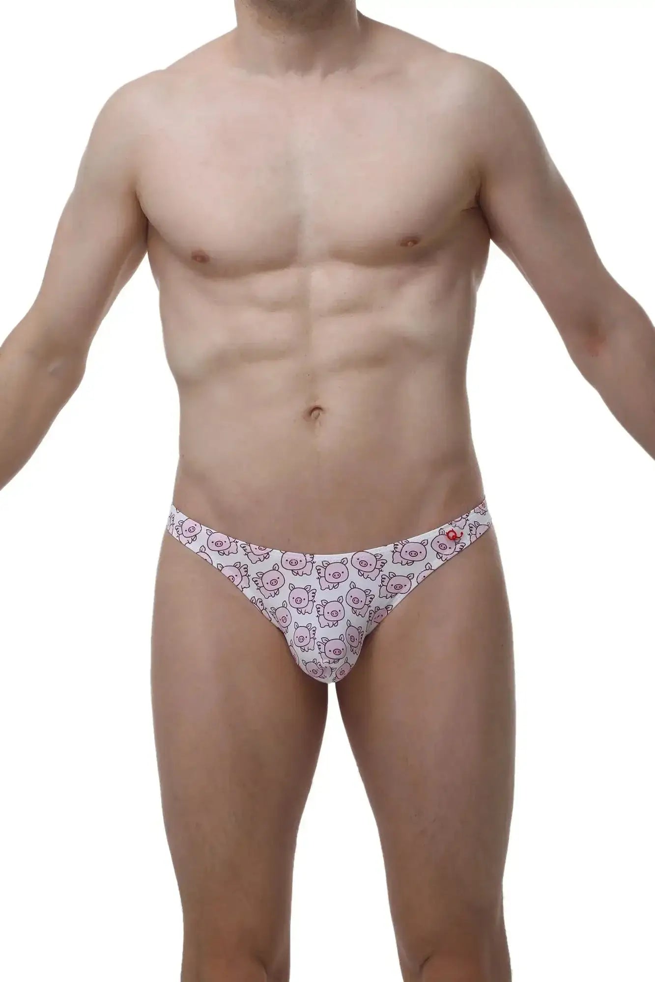 White petitq thong featuring a repeating pattern of pink cartoon pig faces in a soft cotton blend fabric