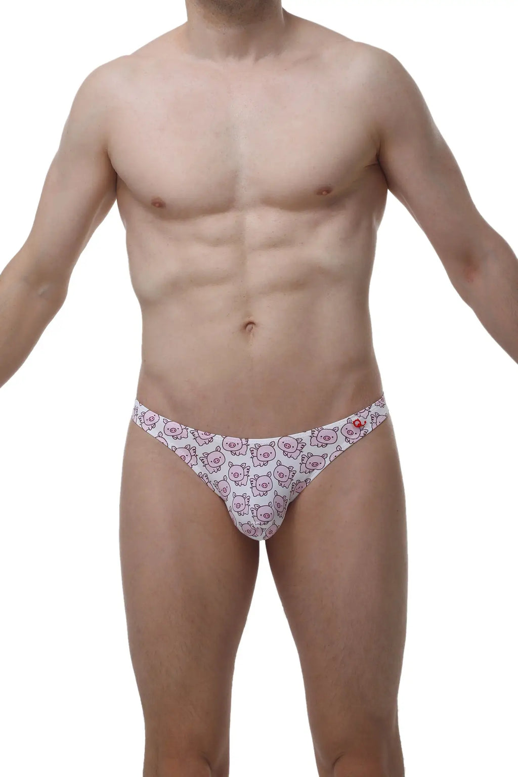 White petitq thong featuring a repeating pattern of pink cartoon pig faces in a soft cotton blend fabric