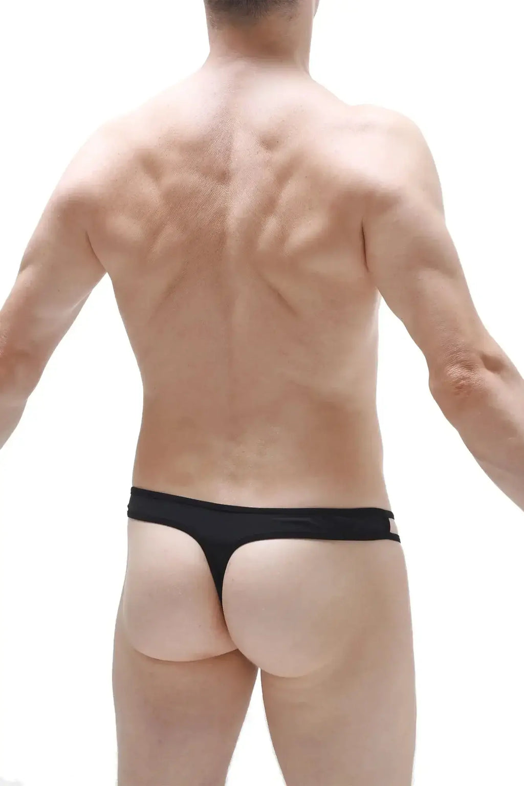 Black thong underwear with narrow waistband and minimal coverage by petitq designed as a cockring in black