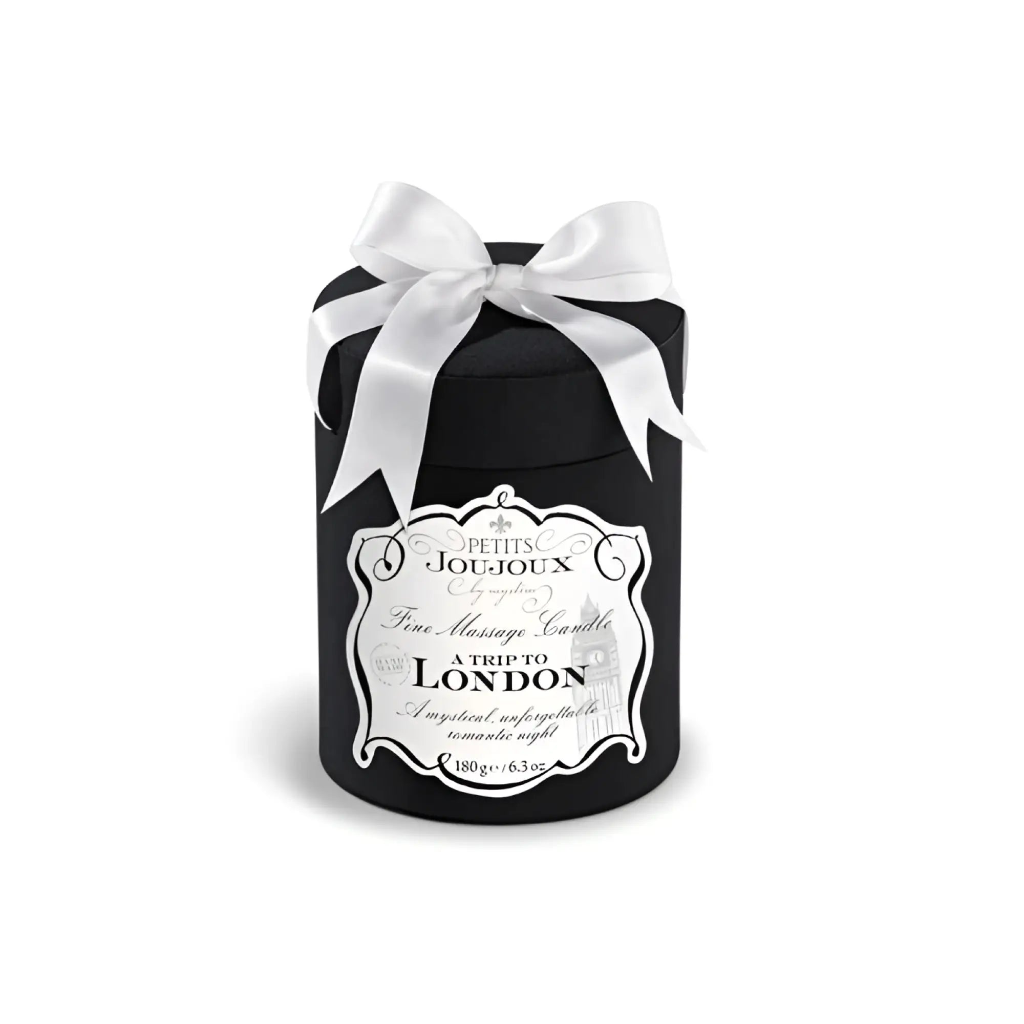 Black cylindrical Petits JouJoux A Trip to London massage candle with white satin bow and ornate silver label 190ml