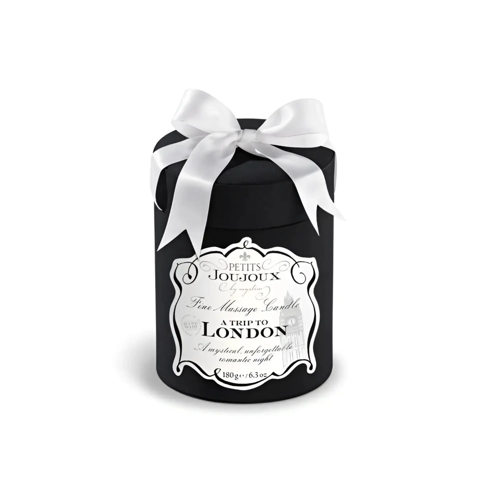 Black cylindrical Petits JouJoux A Trip to London massage candle with white satin bow and ornate silver label 190ml