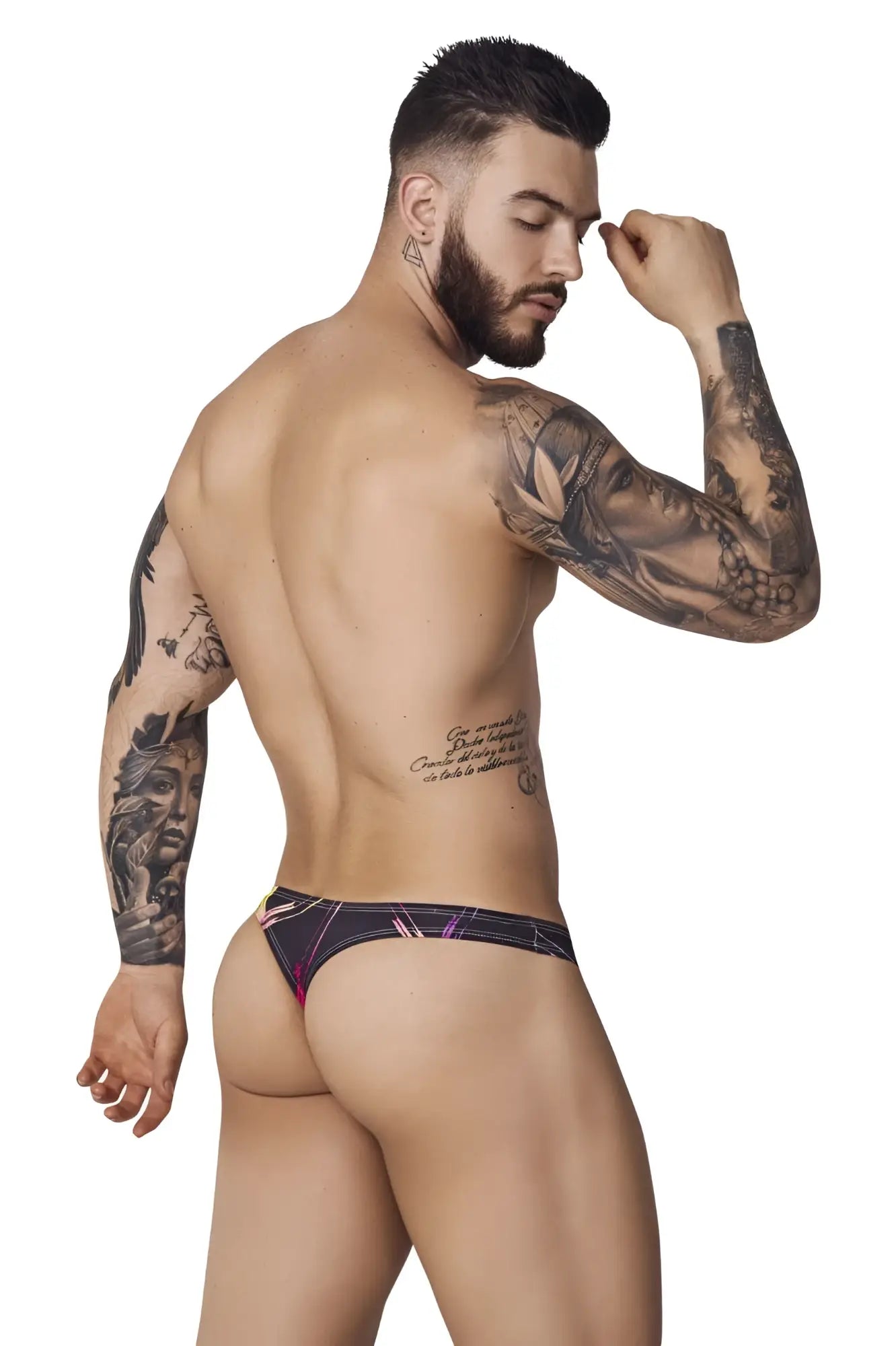 Lifestyle shot of a man wearing black Pikante PIK 1077 Nucleus thongs, showing a back view.