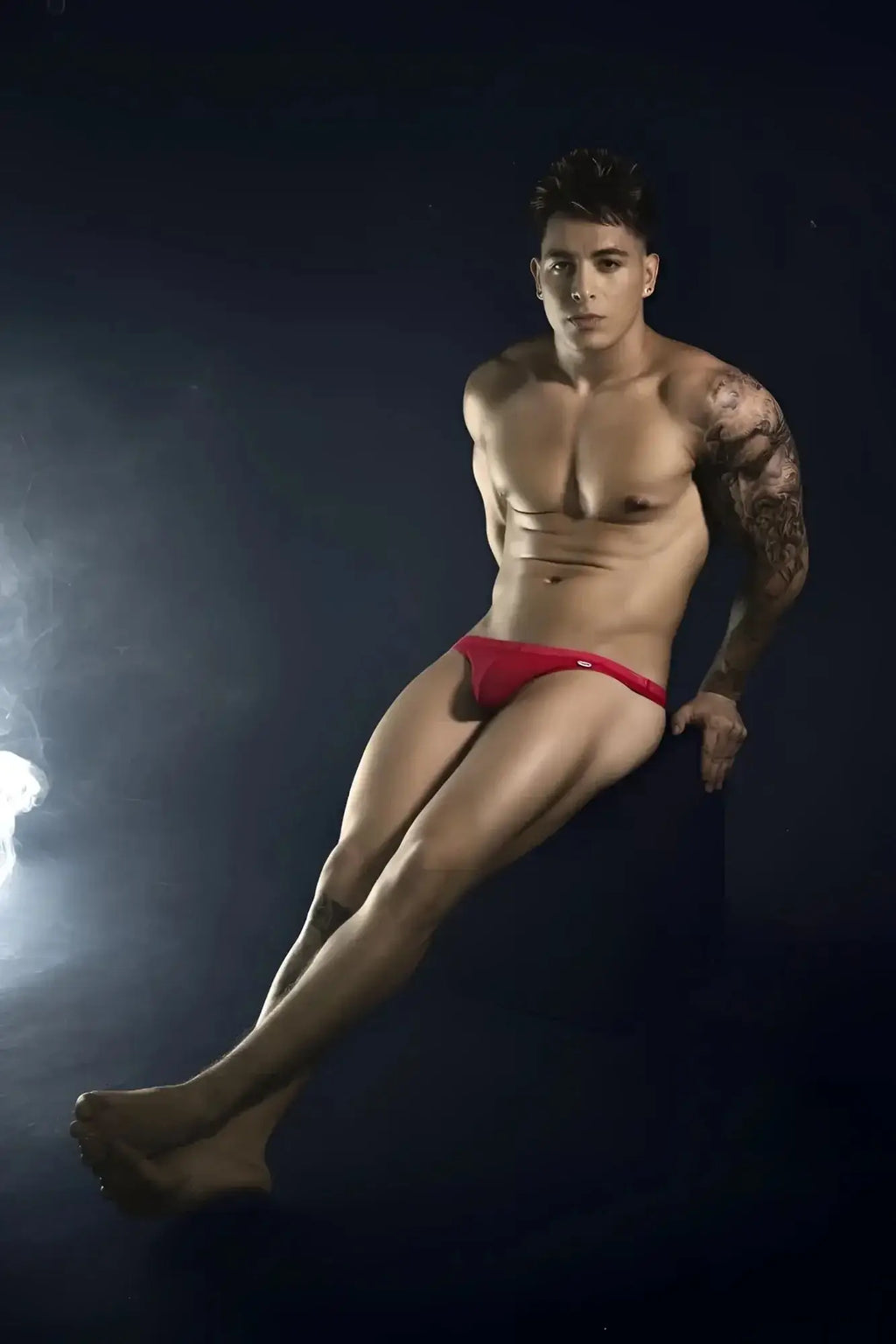 Lifestyle shot of a man wearing red Pikante PIK 1823 luxury thongs.