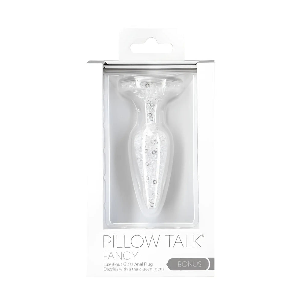 A clear glass anal plug with translucent gemstones in white box labeled pillow talk fancy for luxurious use