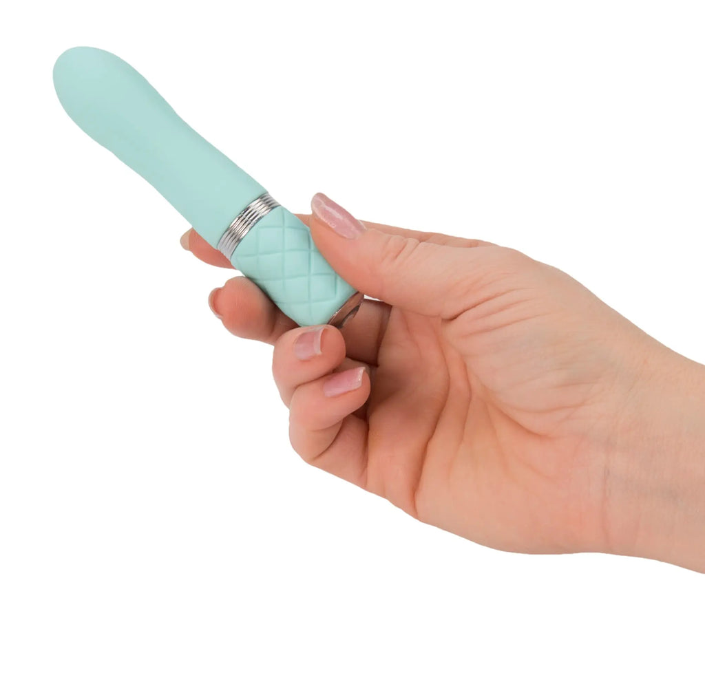 A mint green silicone vibrator with quilted textured grip and silver metallic band from Pillow Talk Flirty Teal