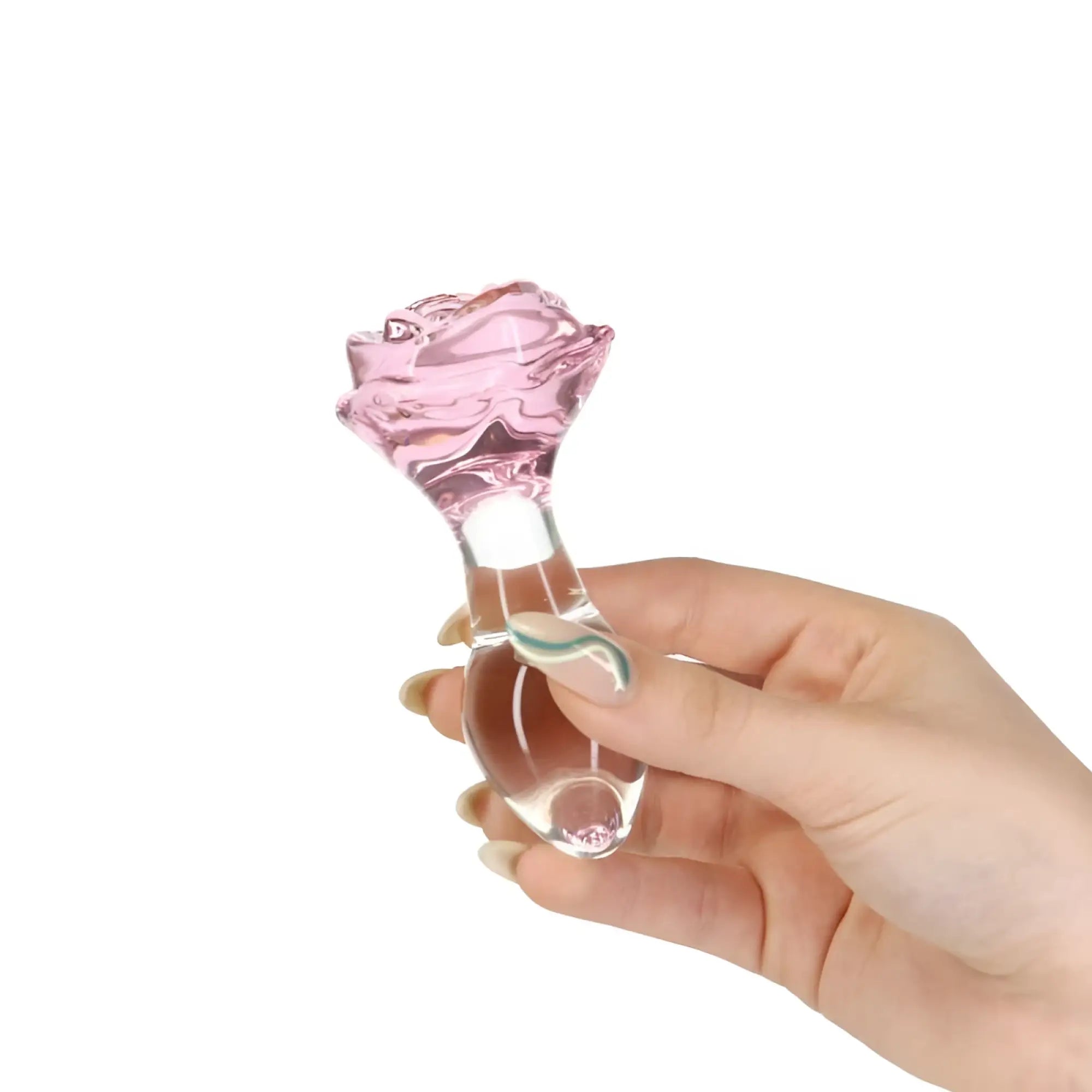 A translucent pink glass rose-shaped pillow talk luxurious anal plug with a clear stem and base held in hand
