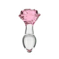 A translucent pink rose-shaped glass anal plug with a clear rounded base from pillow talk rosy luxurious collection