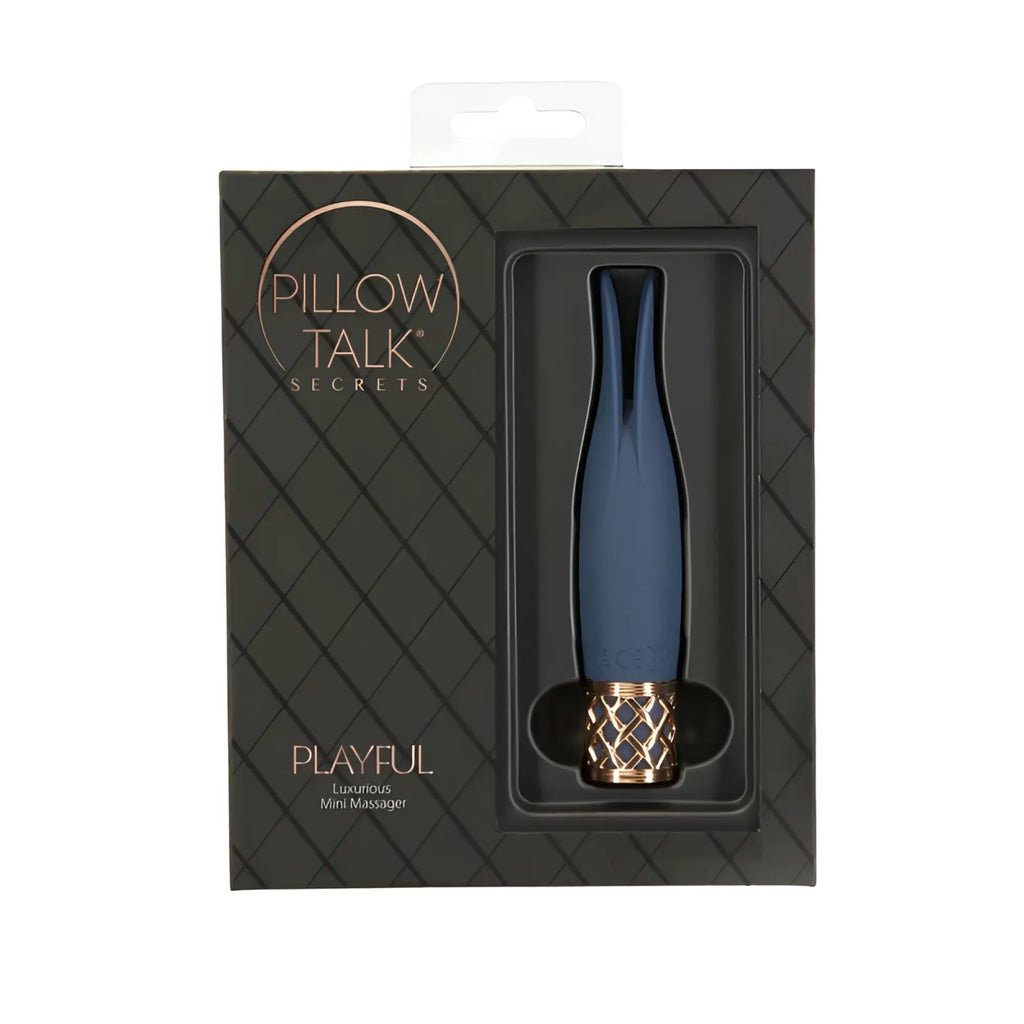 A sleek navy blue pillow talk secrets playful massager with a rose gold textured base for luxurious use