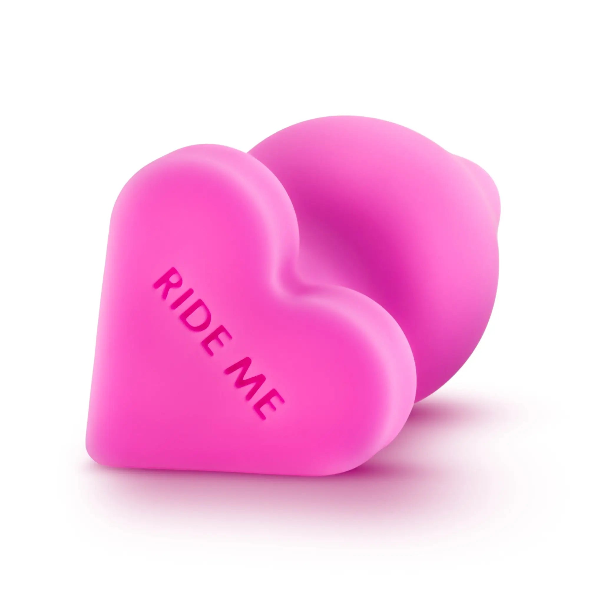 Pink heart-shaped silicone toy Play With Me Naughtier Candy Heart Ride Me with ride me engraved on the front