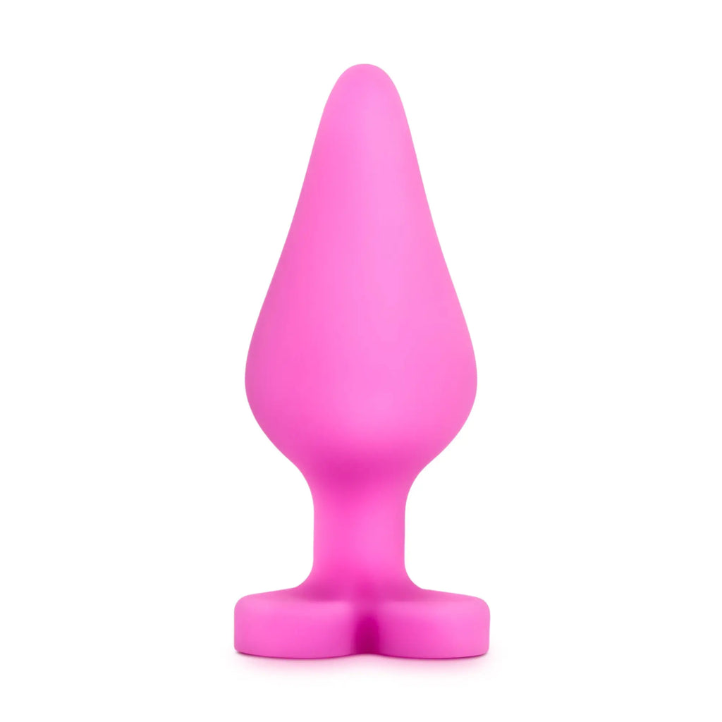 A vibrant pink silicone butt plug with tapered head and wide base from play with me naughty candy heart be mine