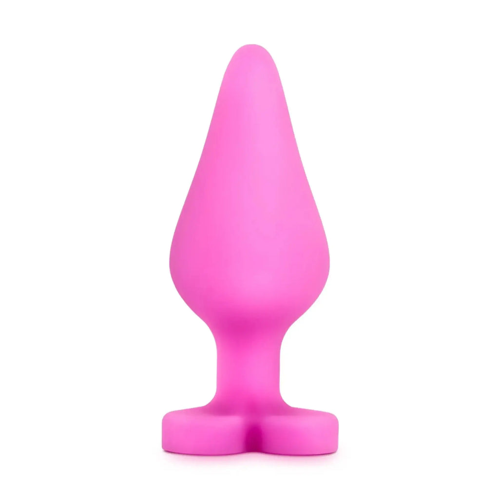 A vibrant pink silicone butt plug with tapered head and wide base from play with me naughty candy heart be mine