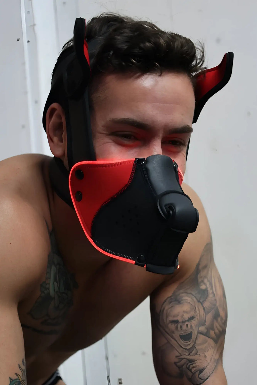 Black and red devil-themed Poundtown Pup Mask 2.0 muzzle with adjustable straps for comfortable fitting