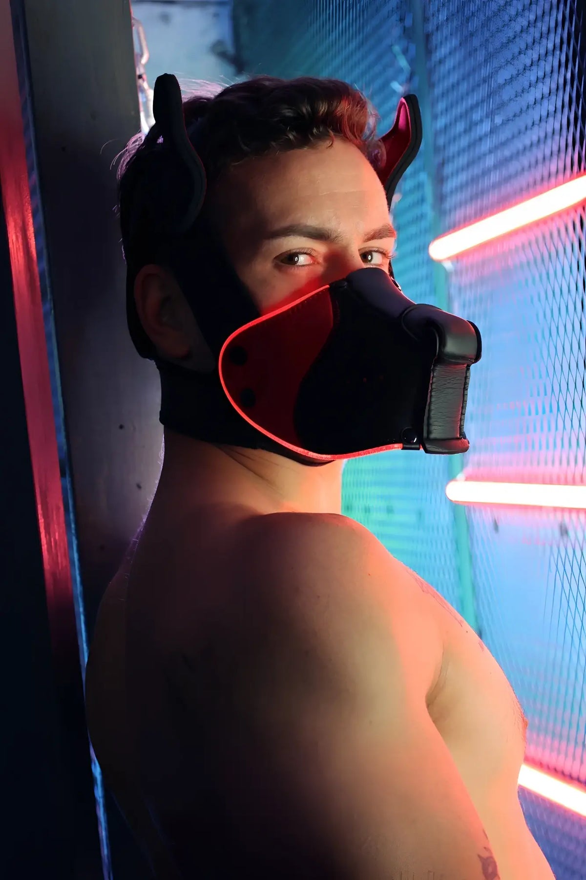 Black and red devil-themed Poundtown Pup Mask 2.0 muzzle with glowing neon trim for stylish pup wear