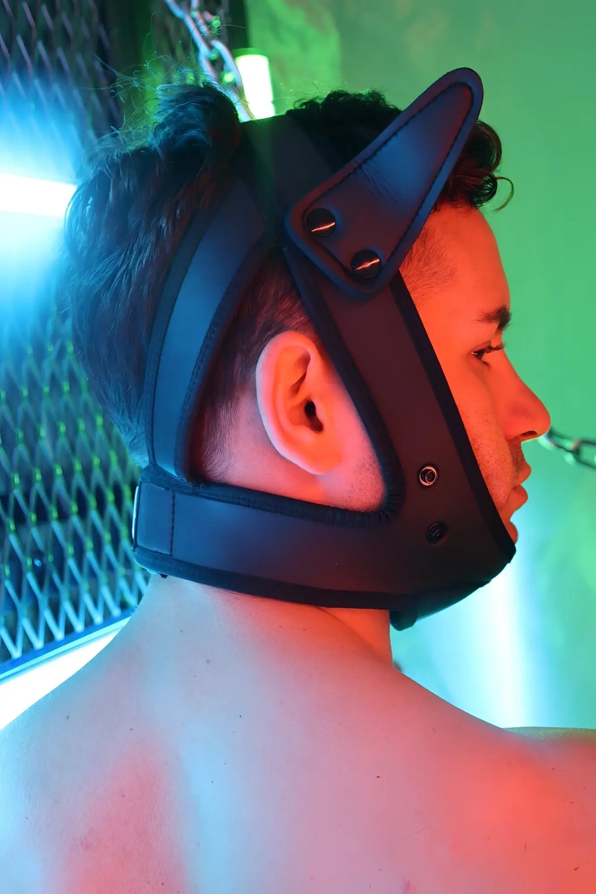 Black leather poundtown pup mask 2.0 red with pointed ear-like protrusions and adjustable straps visible from the back