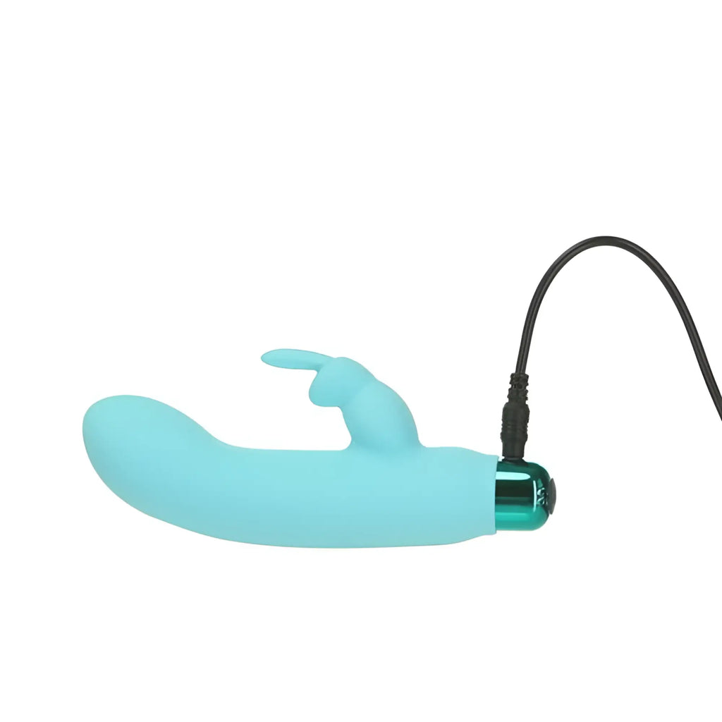 Light blue silicone rabbit-shaped vibrator with metallic green charging port and black cord for rechargeable use