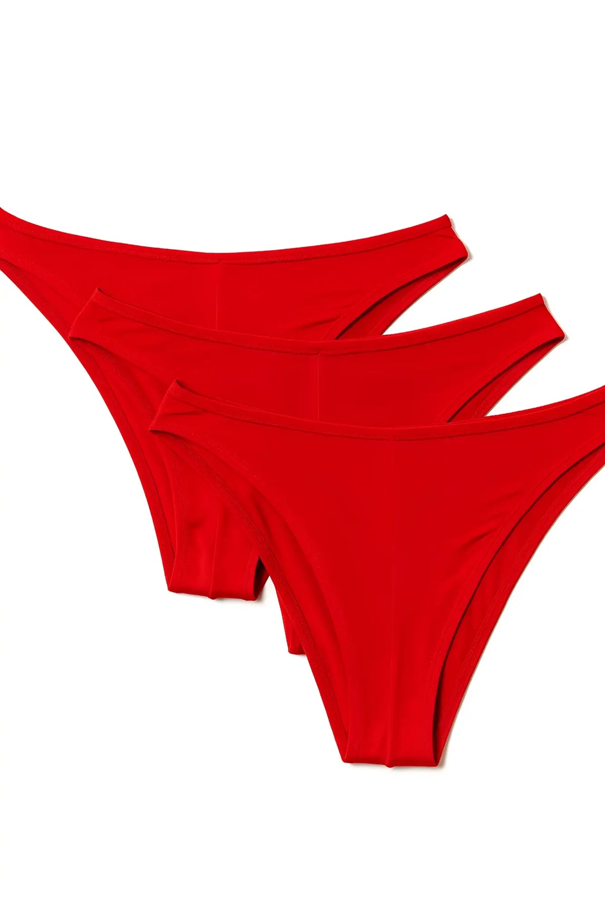 Three vibrant red thong underwear pieces in pride metro rio bikini 3-pack neatly arranged in a diagonal stack