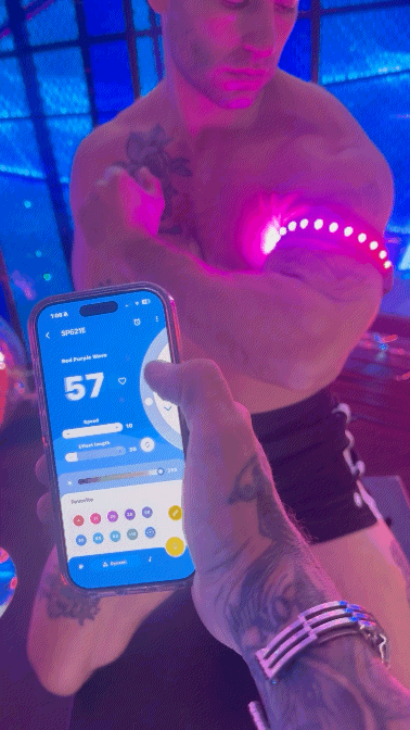 Prismaglow armband glowing pink led light worn on a muscular arm for visibility and style during activities