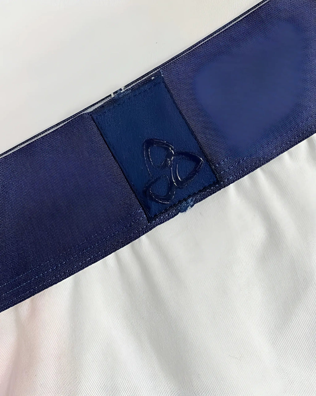 Dark blue elastic waistband with subtle embroidered logo patch on white private structure baut4388 athlete mini briefs