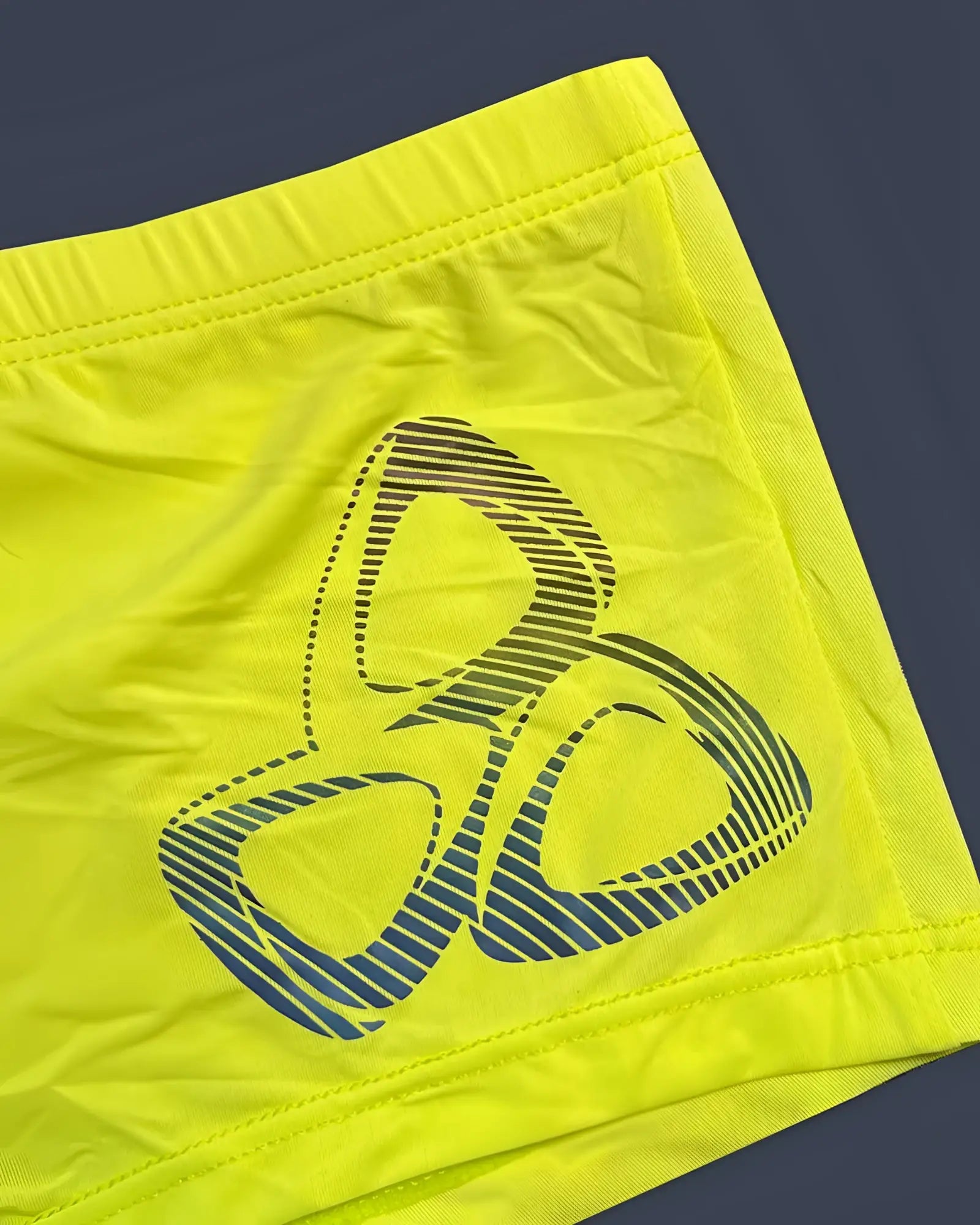 Bright neon yellow Private Structure BRUT4390 Bare Hipster shorts with bold blue and black three-ring logo stripes