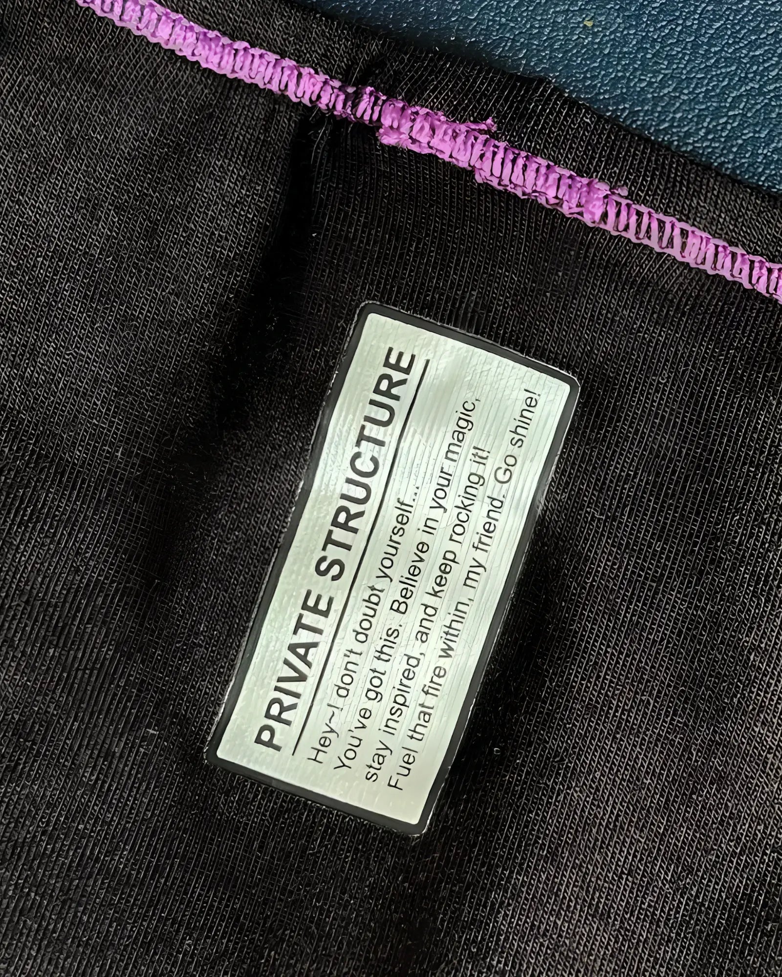 Black private structure epus4563 prime eutopia bikini brief with purple stitched hem and silver label in charcoal color