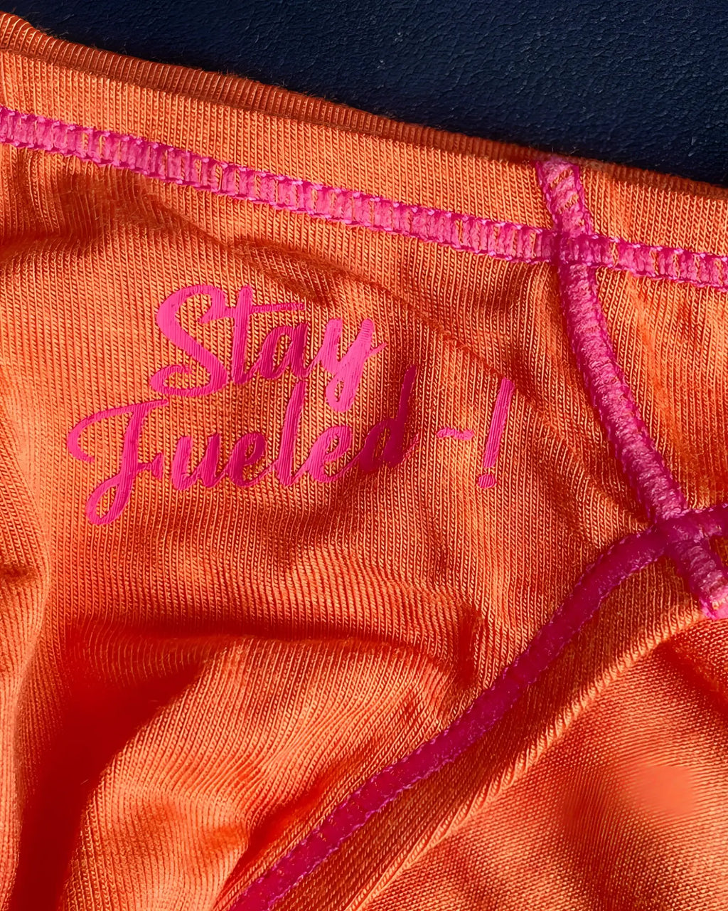 Orange Private Structure EPUS4563 Prime Eutopia bikini brief with pink embroidered text and matching stitching in tangarine