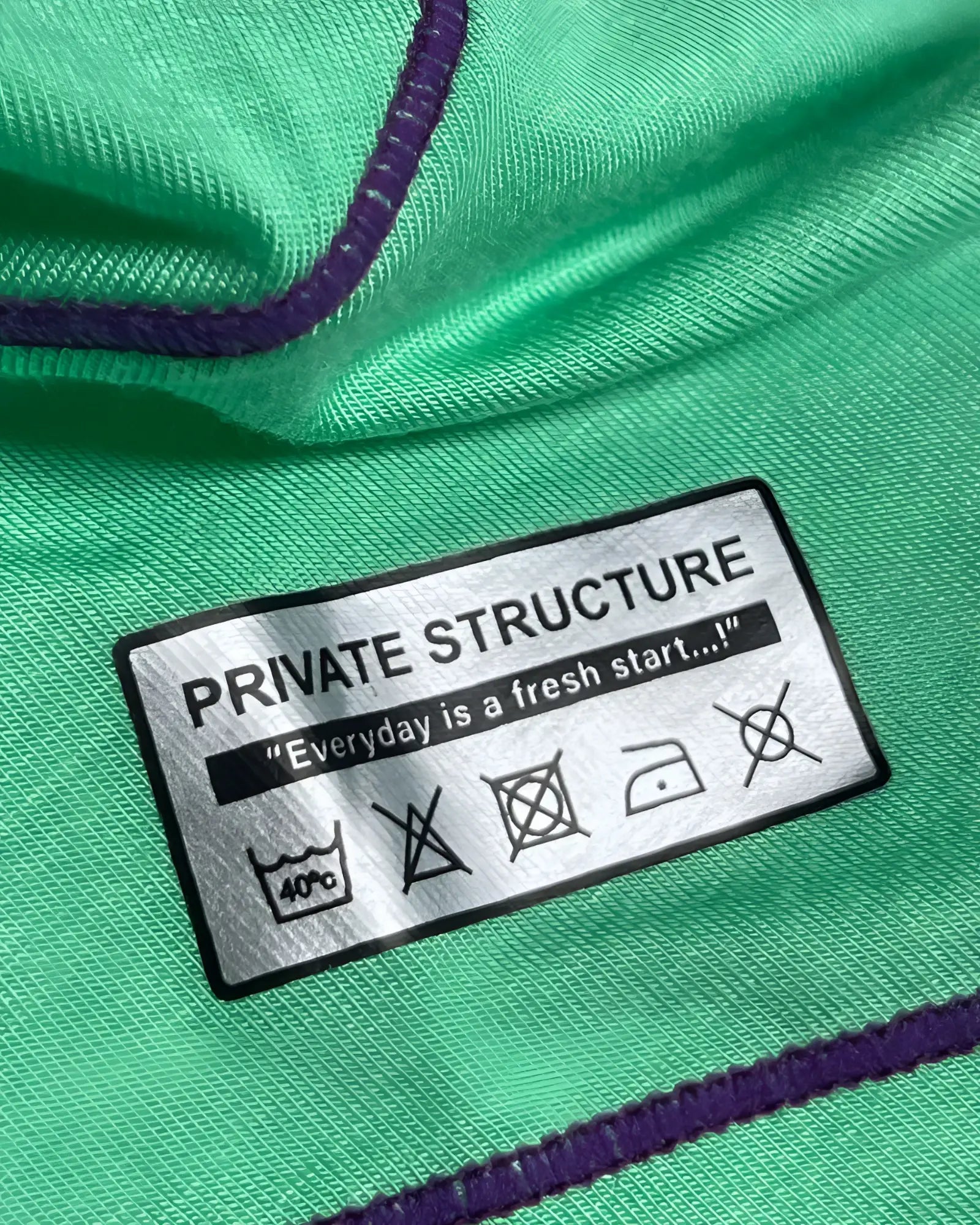 Private structure epus4570 prime elysian hipster cyan fabric with purple stitching and silver label showing care instructions
