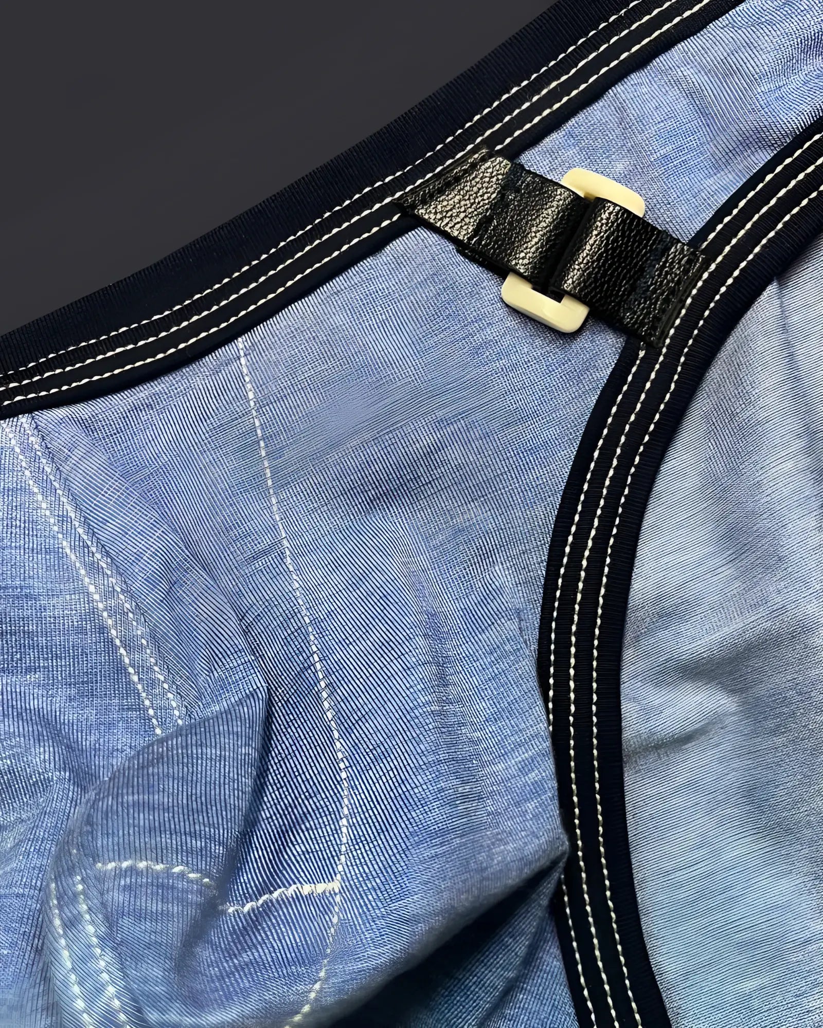 Black leather strap with cream plastic buckle on blue denim fabric of private structure lcut4358 barn boy mini brief