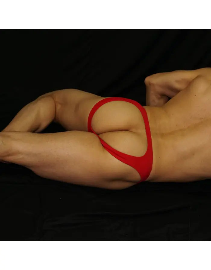 Red bikini jockstrap underwear by Arroyman featuring a minimal design and elastic waistband shown on a model.