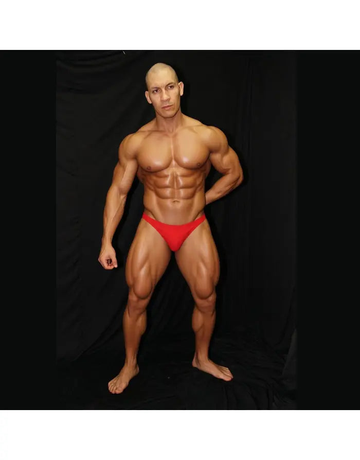 Red bikini jockstrap underwear by Arroyman featuring a snug fit and minimal coverage modeled by a muscular man.