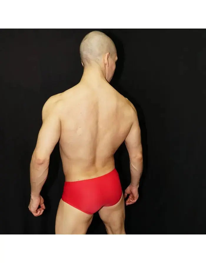 Men's red Brazilian sunga swimwear by Arroyman featuring a snug fit and minimal coverage shown on a model from the back.