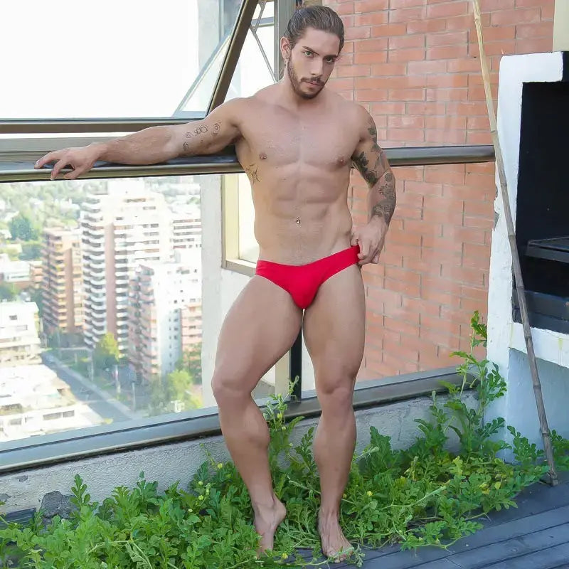 Red bikini swimwear by Arroyman featuring a snug fit worn by a model with a city backdrop.