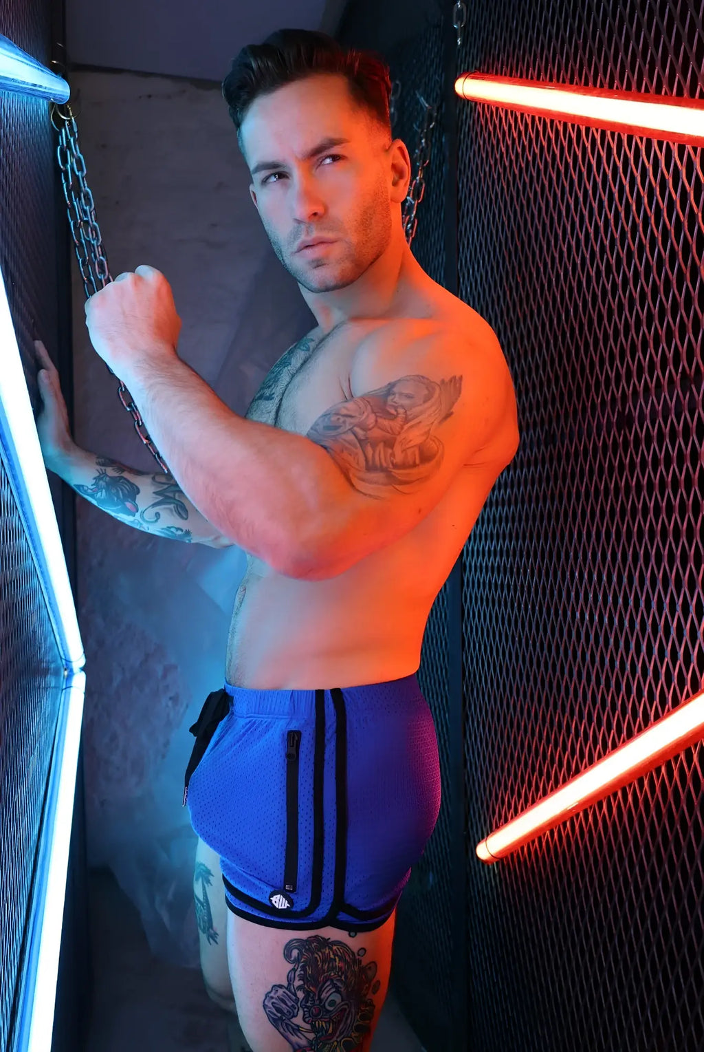 Blue remix circuit shorts 2.0 with black side stripes and metallic button at waistband made for athletic use