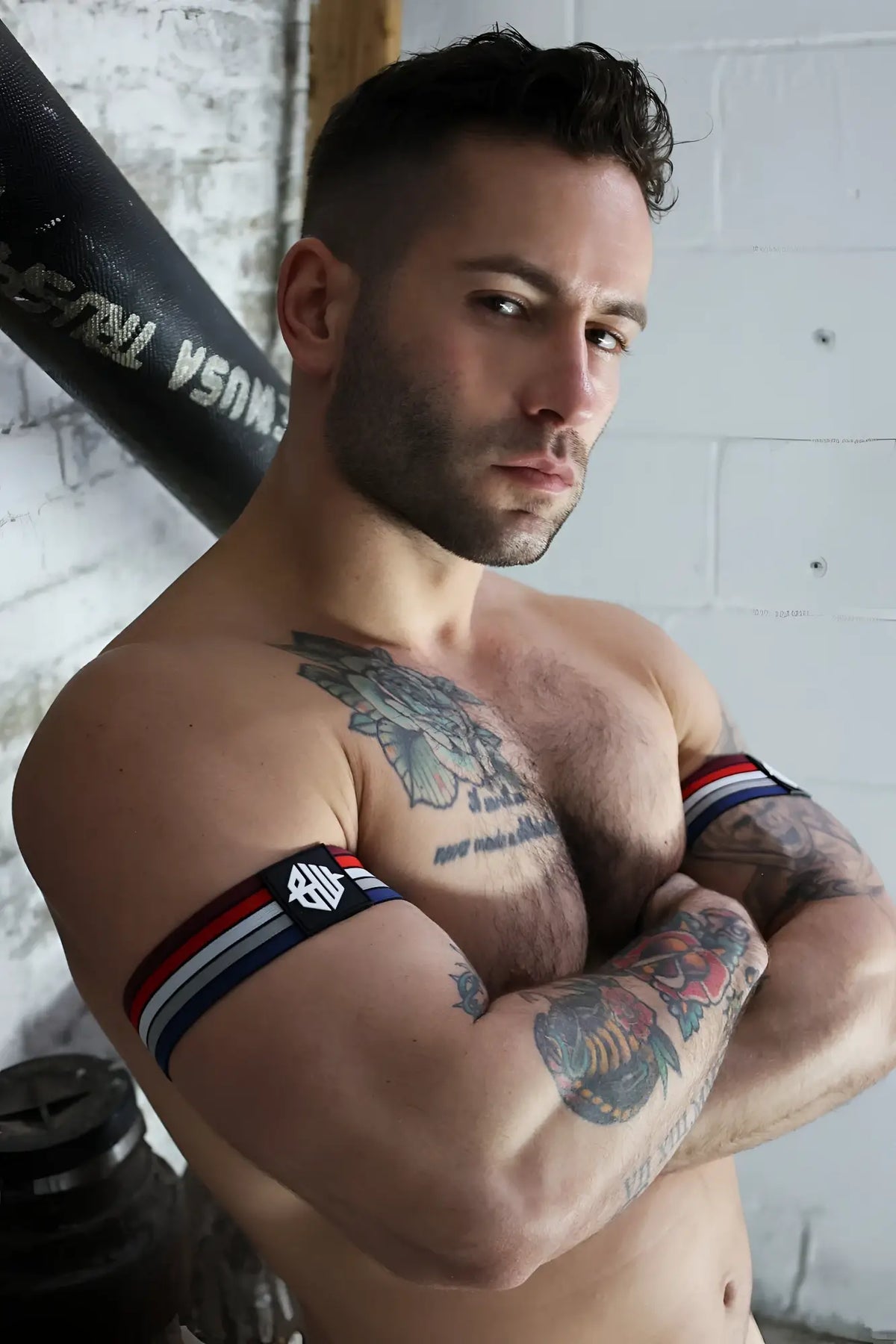 Retro remix armband featuring black red and white stripes with a logo on the left side for athletic use