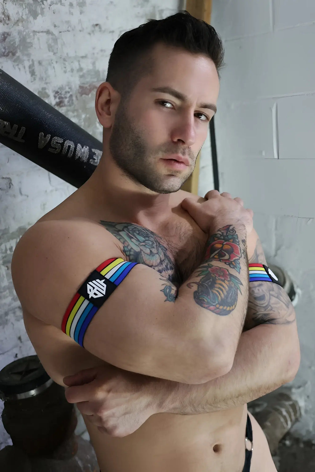 Retro remix armband with rainbow-striped band and black panel featuring a white geometric logo design
