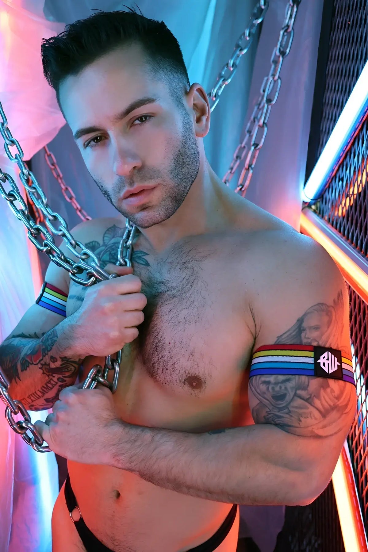Retro remix armband with rainbow-striped fabric and a black square logo featuring white lettering