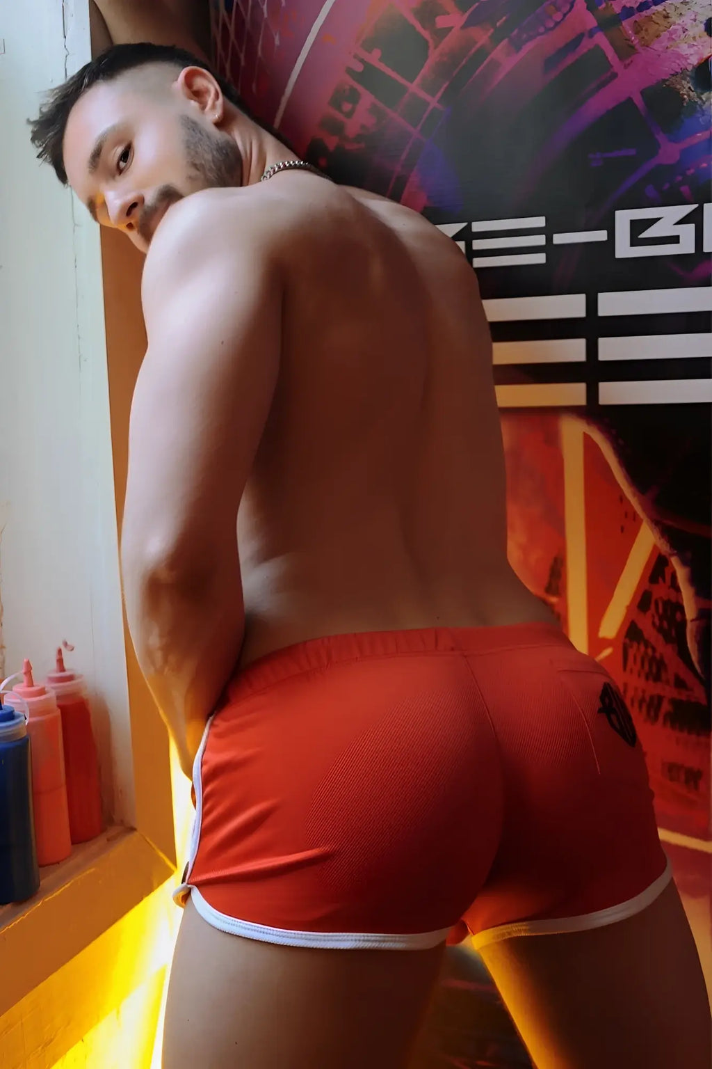 The back of bright red retro remix athletic shorts with white trim and a small black logo for activewear