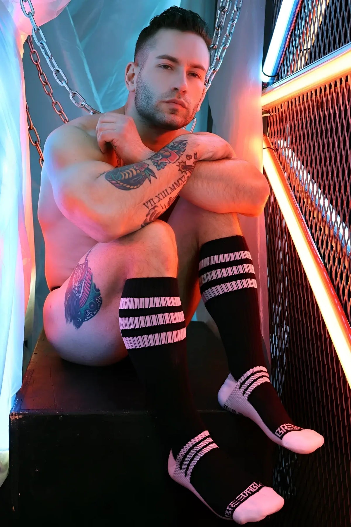 Black knee-high retro remix socks with three white stripes and pink toe caps featuring a subtle brand logo