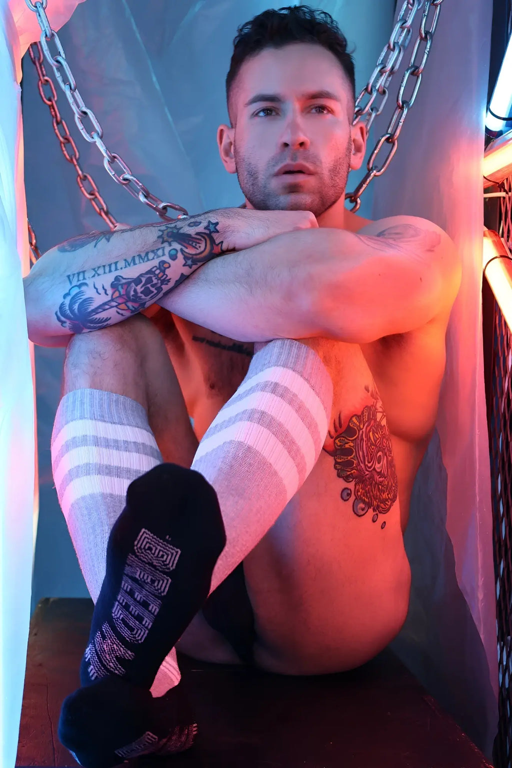 Black sock with white geometric pattern and text on heel shown from the back in retro remix socks design