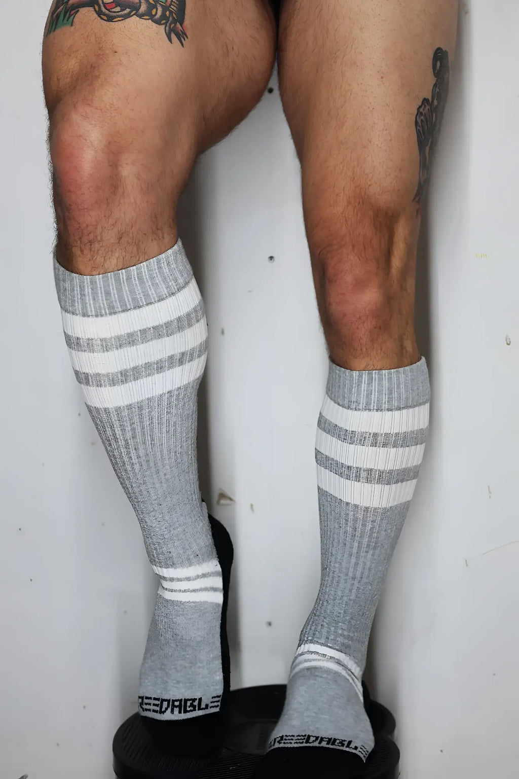 Gray retro remix socks with three white stripes and ribbed texture showing dables brand name on the back heel