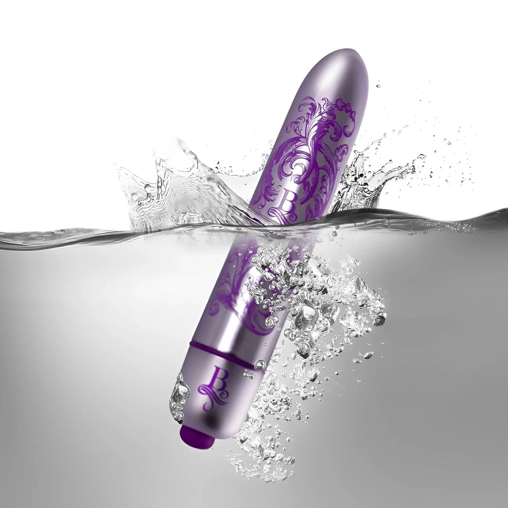A sleek metallic purple Rocks Off Boudoir Duke of Swoon bullet vibrator with ornate floral designs and glossy finish