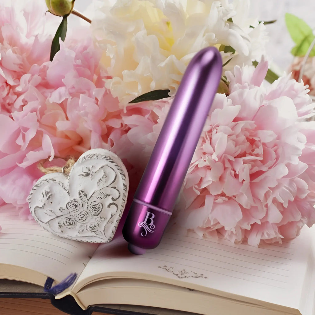 Purple metallic cylindrical vibrator with sleek smooth finish and engraved b logo on base rocks off boudoir parlour prince bullet