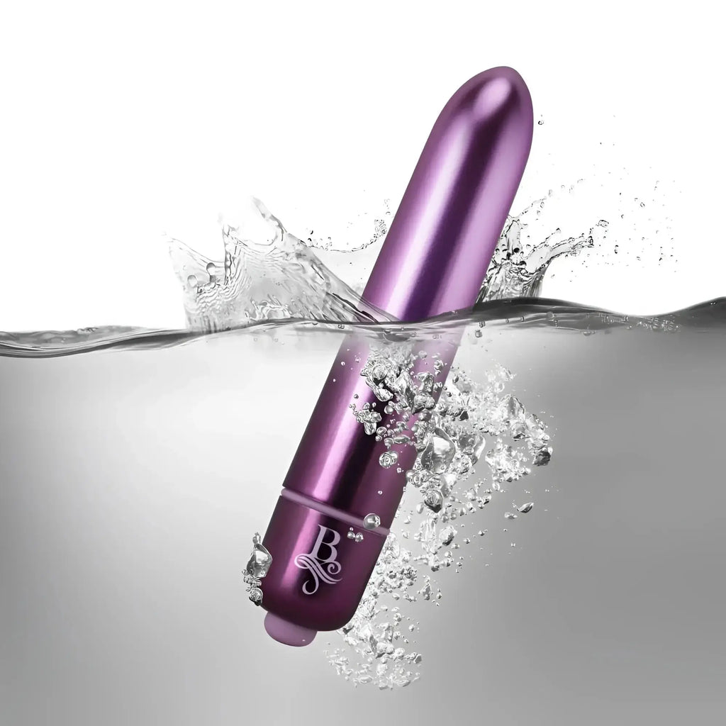 Purple metallic cylindrical vibrator with smooth surface and engraved logo near base rocks off boudoir parlour prince bullet